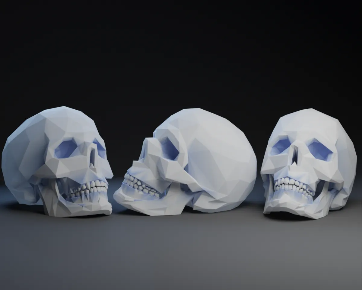 Three low-poly 3D-printed skull sculptures in white displayed side by side on a dark background.