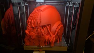 Front view of cosplay helmet 3D printed using QIDI PLUS4 showing vibrant red filament quality