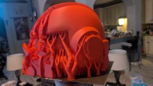 Detailed cosplay helmet 3D printed on QIDI PLUS4 showing intricate texture details, left angle view